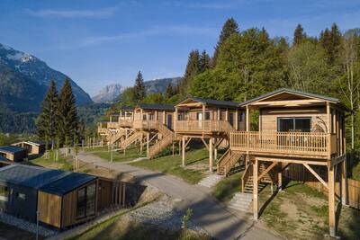 Mehrere Ferienhäuser auf Stelzen in den Bergen bei Alps Resorts Chalets und Glamping Nassfeld