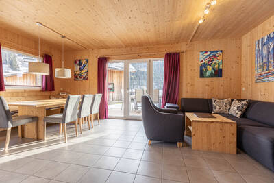 Wohnzimmer mit Schiebetür eines Ferienhauses im Alps Resorts Feriendorf Murau