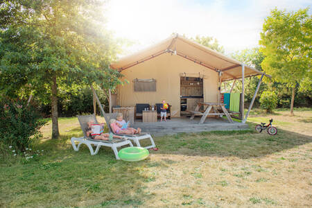Die Familie entspannt sich in einem Safarizelt im Ferienpark RCN la Ferme du Latois